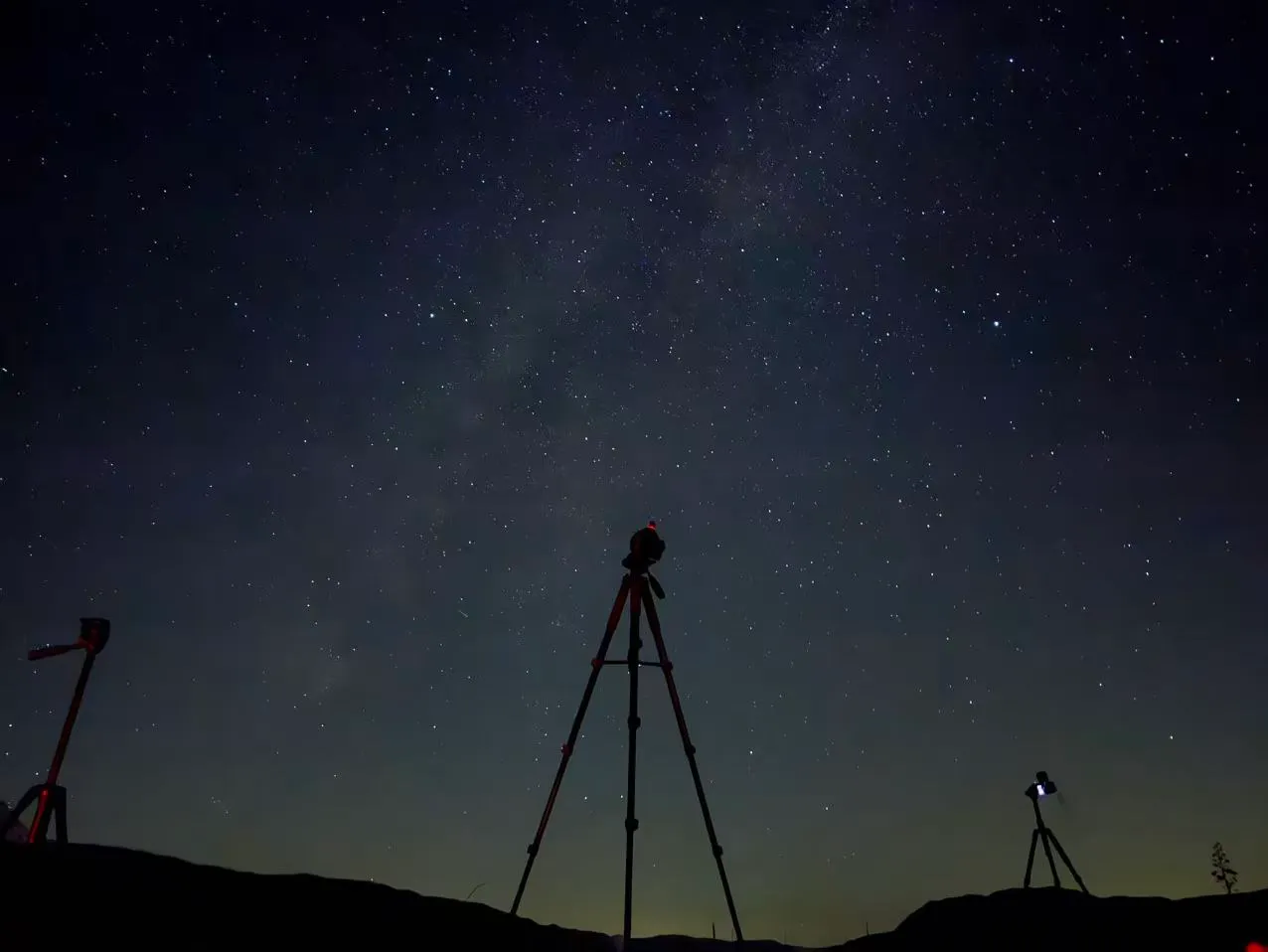 Tripods under the night sky