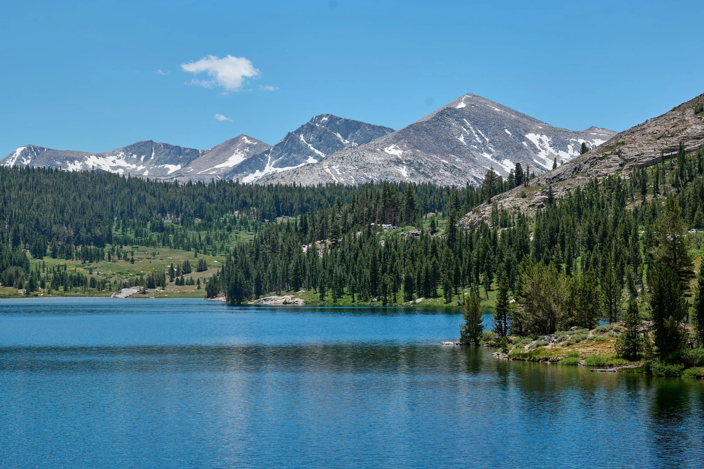An alpine lake under the snow-dappled Sierra crest